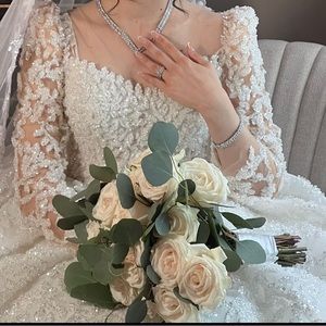 Fully beaded long sleeve wedding gown size 2-4 includes veil and bornos jacket.